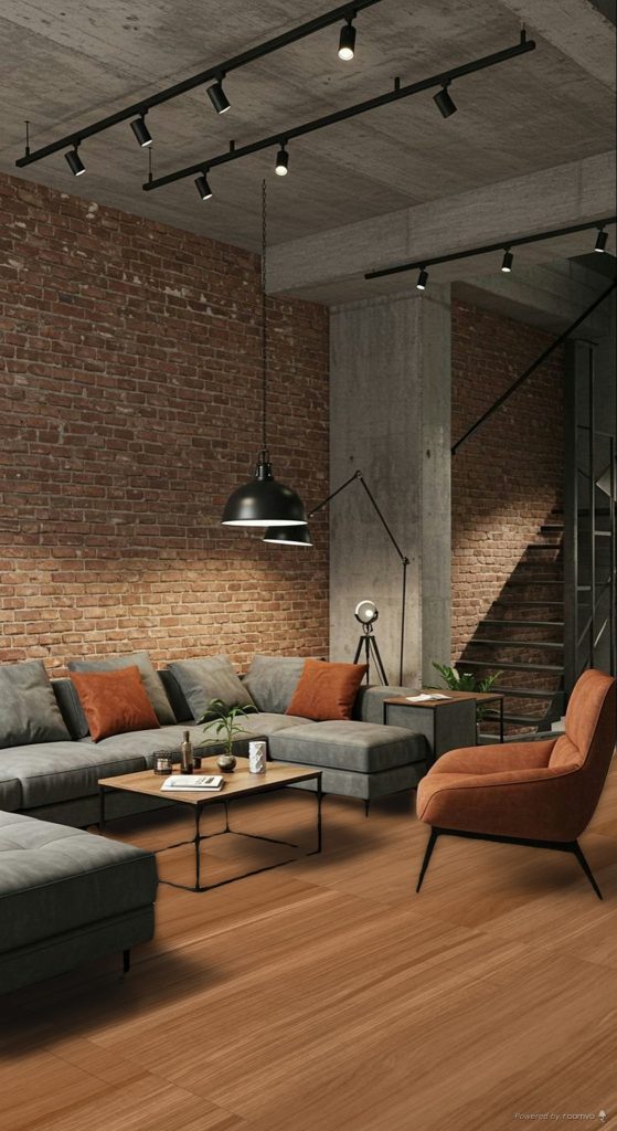 Sala contemporánea con acabados tipo madera, iluminación cálida y texturas naturales que reflejan la tendencia 2026 hacia espacios más sensoriales y acogedores.